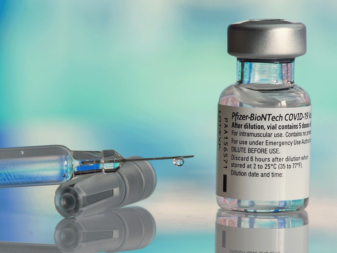 Galati, Romania - February 16, 2021: Pfizer Biontech vaccine and syringe to protect against coronavirus COVID-19 disease.