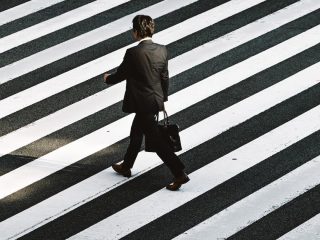 Man walking on pedestrian by Ryoji Iwata